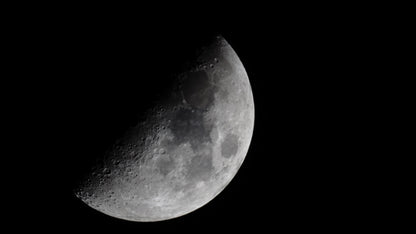 Partial view of the moon through a telescope against a black background