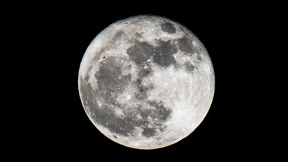 Full moon with a detailed surface on a black background